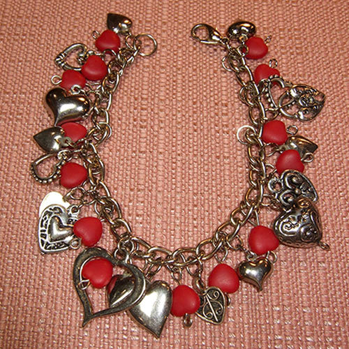 BR-197 Hearts, hearts and more hearts dangle from the silver chain bracelet.