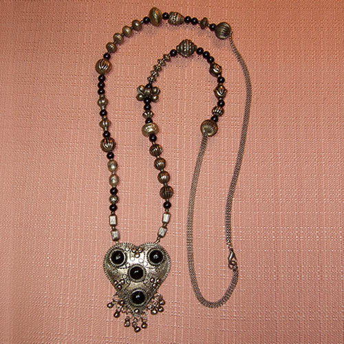 M-43 The Indian decorative tin silver heart is the show piece in this necklace.
