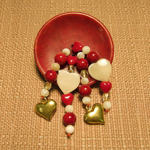 P-108 Vintage plastic button with mother-of-pearl, red glass and gold hearts.