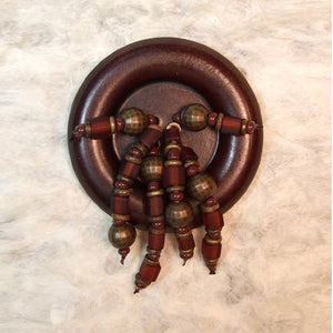 P-104 Matte finish African brass and glass beads on a vintage, wood-tone button.
