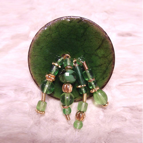 P-119 Green glass and gold beads on an enameled wood button.