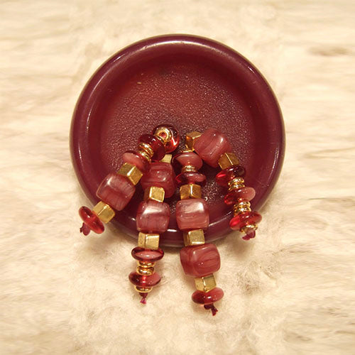 P-122 Raspberry glass cubes and gold beads on vintage bakelite button.