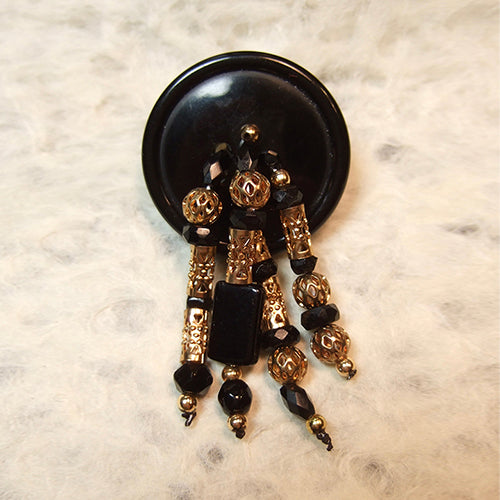 P-85 Faceted glass, Czech glass seed and gold beads on a plastic button.
