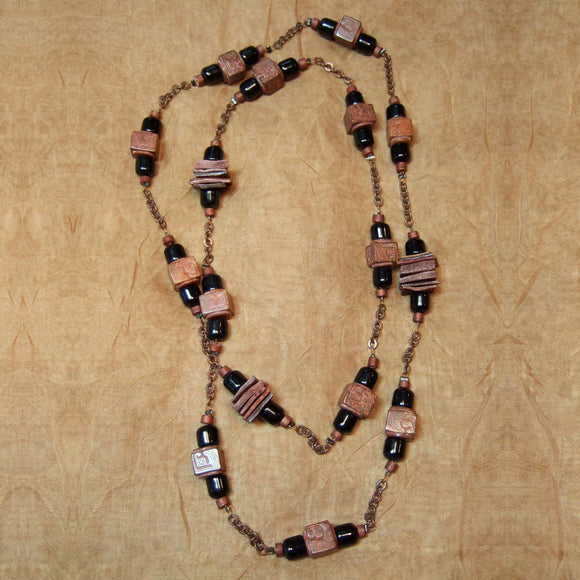 S-12  I combined these carved stone beads with black glass from the 50’s, copper chain and dyed shell.