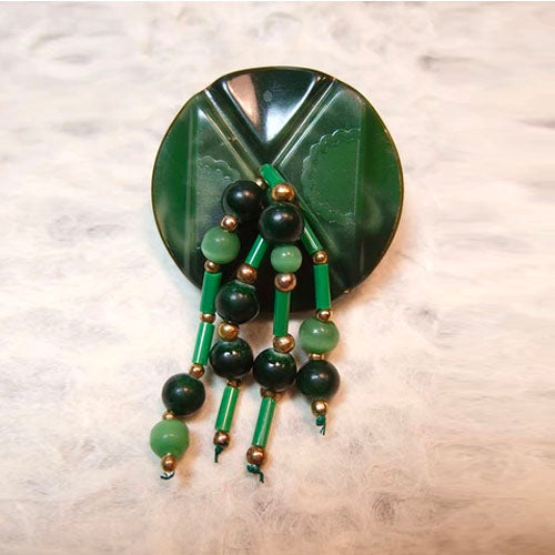 P-83 Glass and brass beads on a carved, plastic two-tone button.